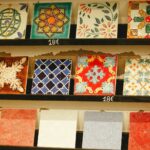 Colorful decorative ceramic tiles displayed on shelves.