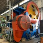 a large red and white machine in a factory